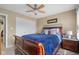 Cozy bedroom with ceiling fan, neutral walls, and double closet for ample storage at 933 Hummingbird Ln, Columbus, IN 47203