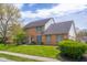 Beautiful two-story brick home with lush green lawn and landscaped garden, featuring a classic and inviting facade at 933 Hummingbird Ln, Columbus, IN 47203