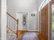 Bright foyer features hardwood floors, staircase, coat closet, and a warm and welcoming atmosphere at 933 Hummingbird Ln, Columbus, IN 47203