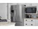 Stainless steel refrigerator and microwave with white cabinets offers a modern touch to the kitchen at 933 Hummingbird Ln, Columbus, IN 47203