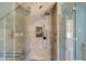 A frameless shower with a bench seat, a glass enclosure, and a tiled alcove for holding soaps and other bathing essentials at 933 Hummingbird Ln, Columbus, IN 47203