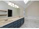 Bright bathroom features a double sink vanity, soaking tub with skylight and marble floors at 950 Nevelle Ln, Carmel, IN 46032