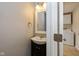 Powder room with ornate mirror and decorative light fixture next to the laundry room at 950 Nevelle Ln, Carmel, IN 46032