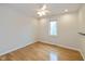This bedroom features hardwood floors, a ceiling fan, a window, and neutral paint at 950 Nevelle Ln, Carmel, IN 46032