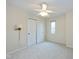 Carpeted bedroom with ceiling fan, window, and closet for ample storage space at 950 Nevelle Ln, Carmel, IN 46032