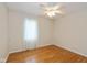 This bedroom features hardwood floors, a ceiling fan, and natural light through the window at 950 Nevelle Ln, Carmel, IN 46032
