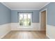 Dining room featuring hardwood floors, wainscoting, and a large window at 950 Nevelle Ln, Carmel, IN 46032