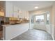 Eat-in kitchen with stainless steel appliances, tiled floor, white cabinets, and breakfast nook at 950 Nevelle Ln, Carmel, IN 46032