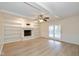 Spacious living room with fireplace, ceiling fan, and hardwood floors at 950 Nevelle Ln, Carmel, IN 46032