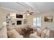 Bright living room with a fireplace, built-in bookshelves, and hardwood floors at 950 Nevelle Ln, Carmel, IN 46032