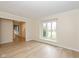 Bright living room featuring hardwood floors and a large window with a window seat at 950 Nevelle Ln, Carmel, IN 46032