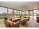 Cozy sun room with screened windows, wood flooring, and comfortable seating at 950 Nevelle Ln, Carmel, IN 46032