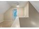 Carpeted attic space featuring neutral walls, a doorway, and access to additional storage at 961 Parkside Dr, Columbus, IN 47203