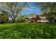 Lush backyard featuring a covered patio, mature trees, and a spacious lawn, creating a private oasis at 961 Parkside Dr, Columbus, IN 47203