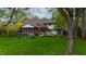 Expansive backyard view with a covered patio, lush greenery, and mature trees, perfect for outdoor living at 961 Parkside Dr, Columbus, IN 47203