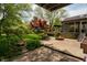 Landscaped backyard featuring a fire pit, wooden deck, and mature trees for privacy and shade at 961 Parkside Dr, Columbus, IN 47203