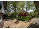 Spacious backyard featuring a fire pit, mature trees, and a wooden deck, perfect for entertaining at 961 Parkside Dr, Columbus, IN 47203