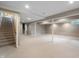 Spacious finished basement with neutral carpet and supporting beams at 961 Parkside Dr, Columbus, IN 47203