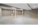 Spacious basement with neutral carpet, white support beams, and a door with glass panels at 961 Parkside Dr, Columbus, IN 47203