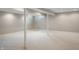 Unfinished basement space with neutral carpet, white support beams and natural light from small windows at 961 Parkside Dr, Columbus, IN 47203