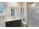 Well lit bathroom featuring a vanity with dark cabinets, shower and window at 961 Parkside Dr, Columbus, IN 47203