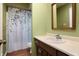 Bathroom features a vanity, mirror, toilet, and shower with a decorative curtain at 961 Parkside Dr, Columbus, IN 47203