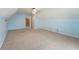 A light blue bedroom featuring carpet flooring, a ceiling fan, and an open doorway at 961 Parkside Dr, Columbus, IN 47203