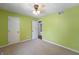 This cozy bedroom features neutral carpet, green walls, and a ceiling fan with a light at 961 Parkside Dr, Columbus, IN 47203
