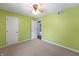 This cozy bedroom features neutral carpet, green walls, and a ceiling fan with a light at 961 Parkside Dr, Columbus, IN 47203