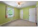 Well-lit bedroom features green walls, carpet flooring, a window and closet at 961 Parkside Dr, Columbus, IN 47203