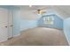 A spacious bedroom with blue walls, carpet flooring, large windows, and ample natural light at 961 Parkside Dr, Columbus, IN 47203