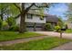 Charming two-story home with a well-maintained lawn, attached two-car garage, and mature landscaping at 961 Parkside Dr, Columbus, IN 47203