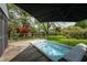 Inviting backyard deck features a hot tub, complete with a sun shade and overlooking a lush, green yard at 961 Parkside Dr, Columbus, IN 47203