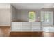 Bright living room with custom shelving, hardwood floors, and view of front yard, creating a cozy atmosphere at 961 Parkside Dr, Columbus, IN 47203