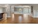 Open-concept layout with hardwood floors connecting living, dining, and kitchen areas, perfect for entertaining guests at 961 Parkside Dr, Columbus, IN 47203