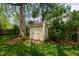 Charming backyard shed providing extra storage and nestled among mature trees and landscaping at 961 Parkside Dr, Columbus, IN 47203