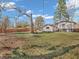 Expansive backyard view with trees, lawn, and fencing surrounding the property at 9829 Chambray Dr, Indianapolis, IN 46280