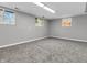 Unfinished basement featuring grey walls, carpeted floors, and multiple windows at 9829 Chambray Dr, Indianapolis, IN 46280