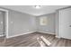 Bedroom featuring neutral walls, a window, wood floors, and a door at 9829 Chambray Dr, Indianapolis, IN 46280