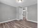 Bedroom featuring grey walls, a light fixture, and a view into another room at 9829 Chambray Dr, Indianapolis, IN 46280