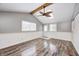 Bonus room features hardwood floors, light walls, skylight and a stylish ceiling fan at 9829 Chambray Dr, Indianapolis, IN 46280