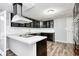 Modern kitchen featuring stainless steel appliances, granite countertops, an island and dark cabinetry at 9829 Chambray Dr, Indianapolis, IN 46280