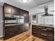Modern kitchen with dark cabinetry, stainless steel appliances, granite countertops, and hardwood floors at 9829 Chambray Dr, Indianapolis, IN 46280