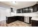 Modern kitchen featuring stainless steel appliances, granite countertops, an island and dark cabinetry at 9829 Chambray Dr, Indianapolis, IN 46280