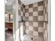 Shower featuring decorative earth-toned tile surround and pebble floor at 9829 Chambray Dr, Indianapolis, IN 46280