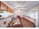 Kitchen area with a counter/ledge looking into living room, with a ceiling fan and cabinetry at 9855 Haven Ct, Indianapolis, IN 46235