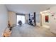 View of the carpeted living room and fireplace with a sliding glass door leading outside at 9855 Haven Ct, Indianapolis, IN 46235