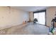 An empty carpeted living room with a sliding glass door and a fireplace along the wall at 9855 Haven Ct, Indianapolis, IN 46235