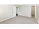 Carpeted bedroom with white trim and a view into the closet and bathroom at 10362 Delphi Ct, Fishers, IN 46038