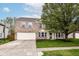 Charming two-story brick home with an attached garage, a well-kept lawn, and mature trees at 10362 Delphi Ct, Fishers, IN 46038